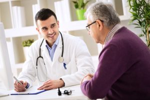 Doctor explaining prescription to senior patient, healthcare concept