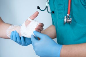 hand surgeon bandaging patient